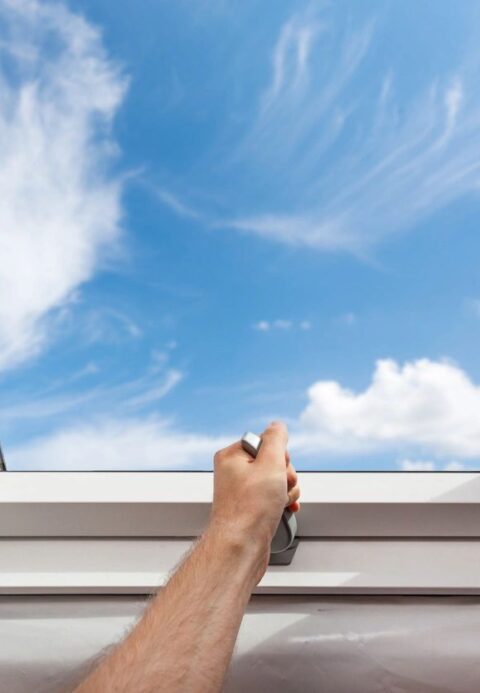 Image of Man opening skylight window